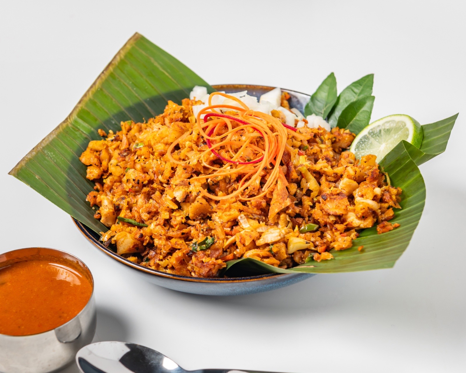 Chicken Kothu - Shredded roti stir-fried with spiced chicken, vegetables, and aromatic curry leaves